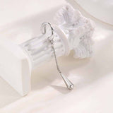 Clips de oreja de acero inoxidable con dije de cruz negra